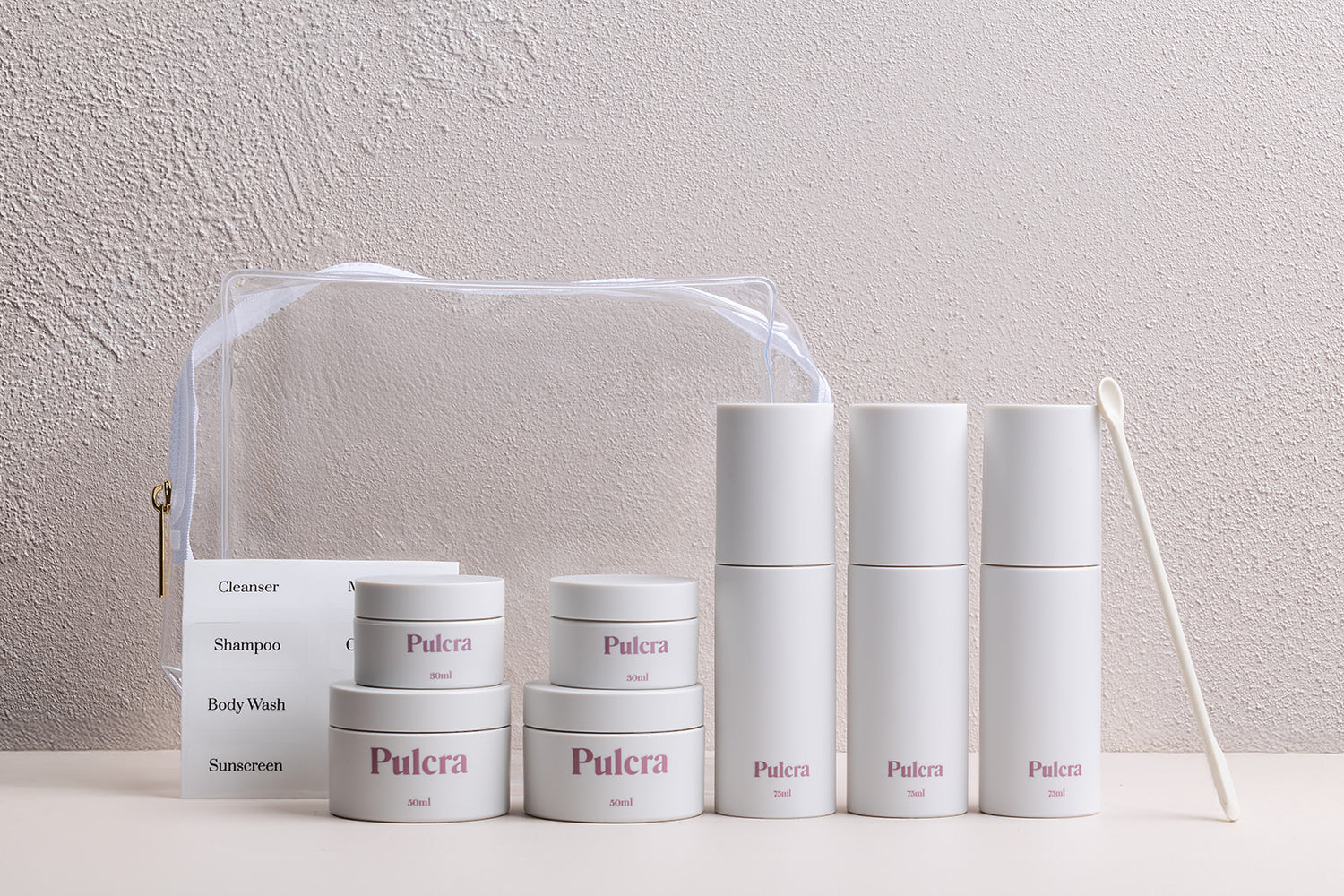 Premium sustainable refillable travel set with reusable bottles and jars for beauty products. 