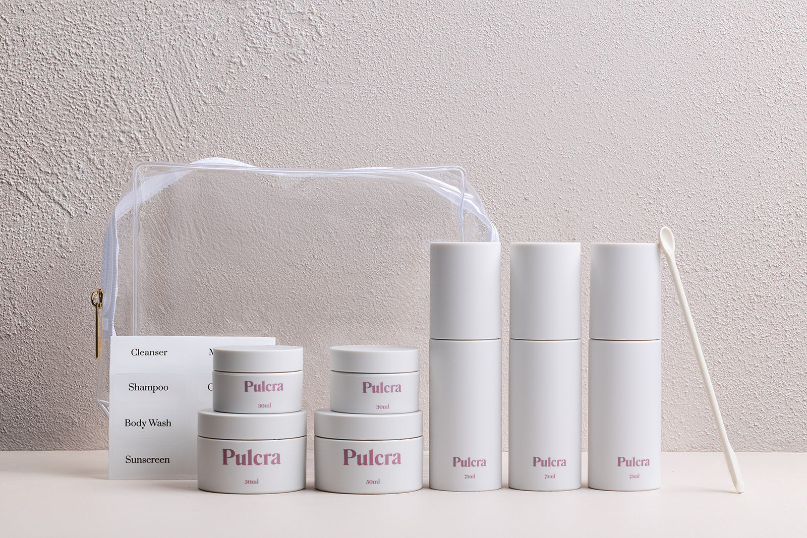 Premium sustainable refillable travel set with reusable bottles and jars for beauty products. 